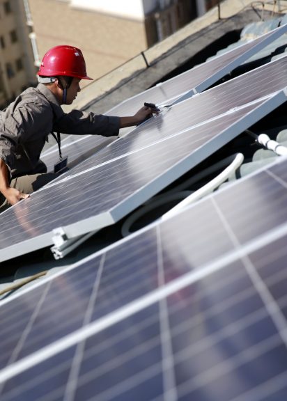 Installing solar panels on a rooftop in Jiujiang, East China